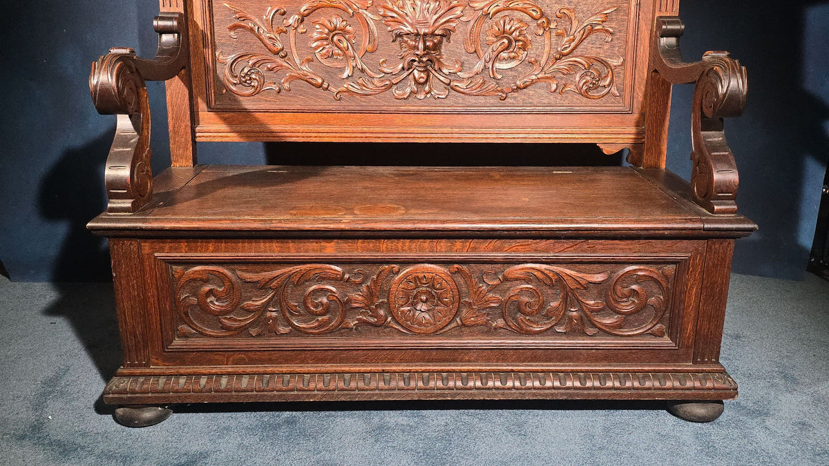 Antique Renaissance Revival Carved Oak Hall Bench with Lift-Top Storage, Green Man, Griffin and Shield Crest