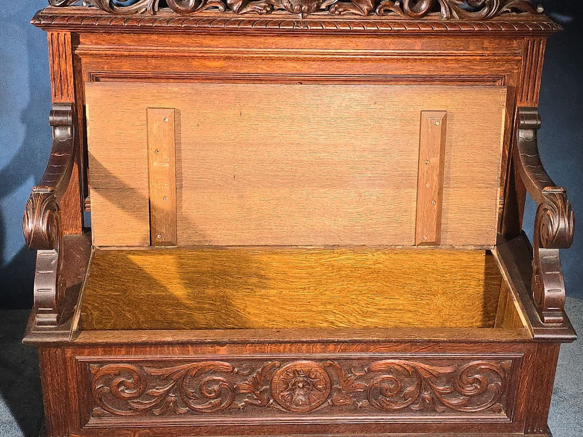 Antique Renaissance Revival Carved Oak Hall Bench with Lift-Top Storage, Green Man, Griffin and Shield Crest