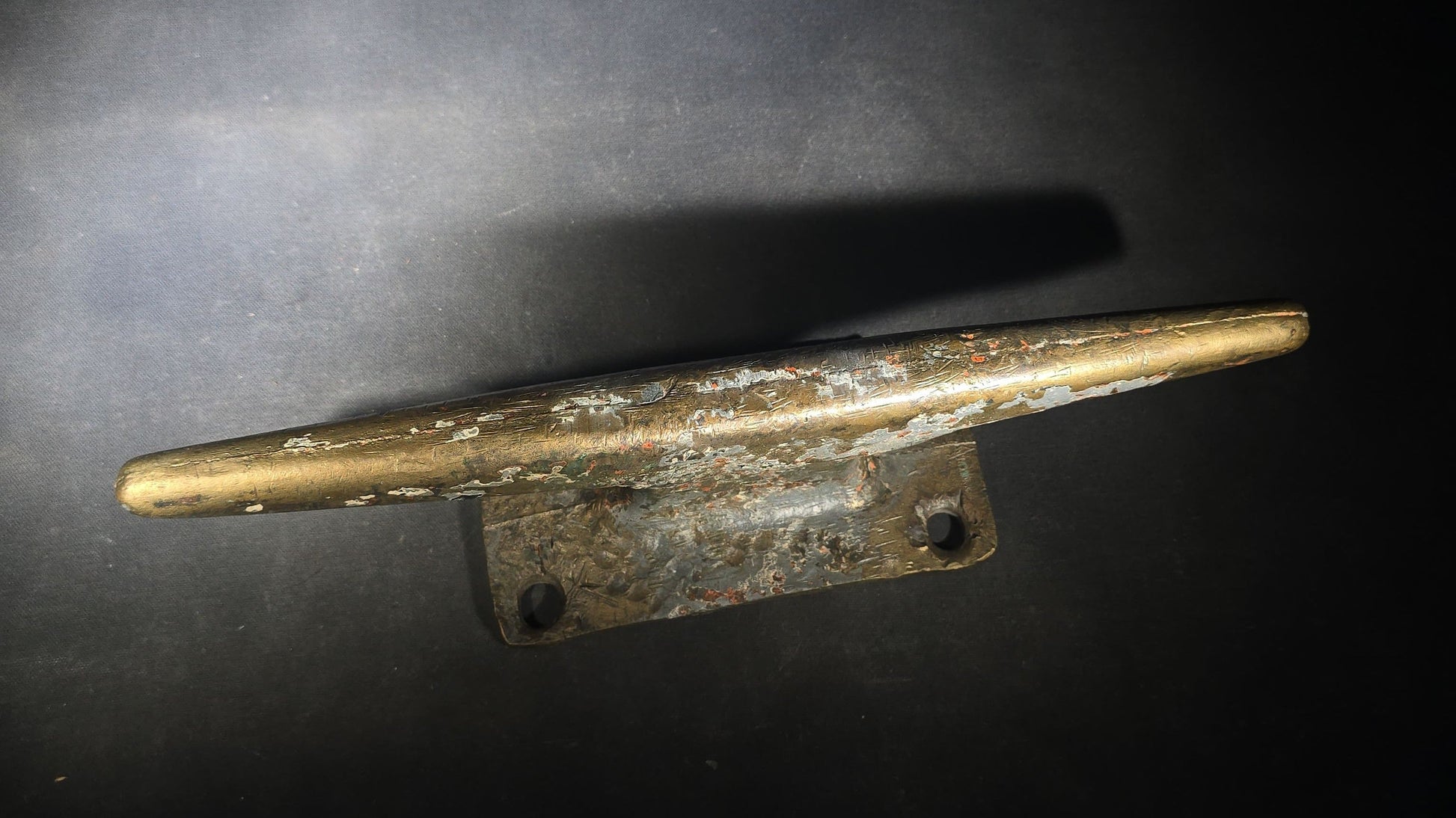 Vintage Bronze Boat Dock Cleat with Layers of Old Paint