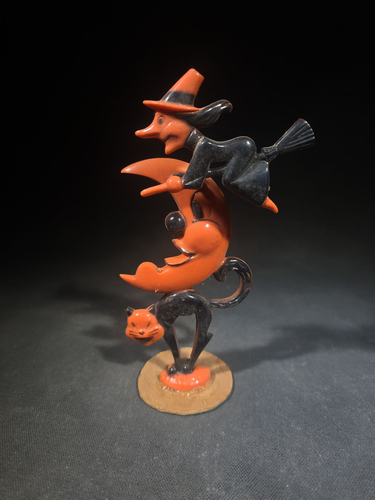 Grouping of Three Vintage Halloween Items including Tin Lithograph Ratchet Noisemaker with Jack-O-Lantern, Black Cat, and Witch Graphics, Manufactured by Kirchhof, Newark, New Jersey, and Two Witch on Crescent Moon and Black Cat Figures