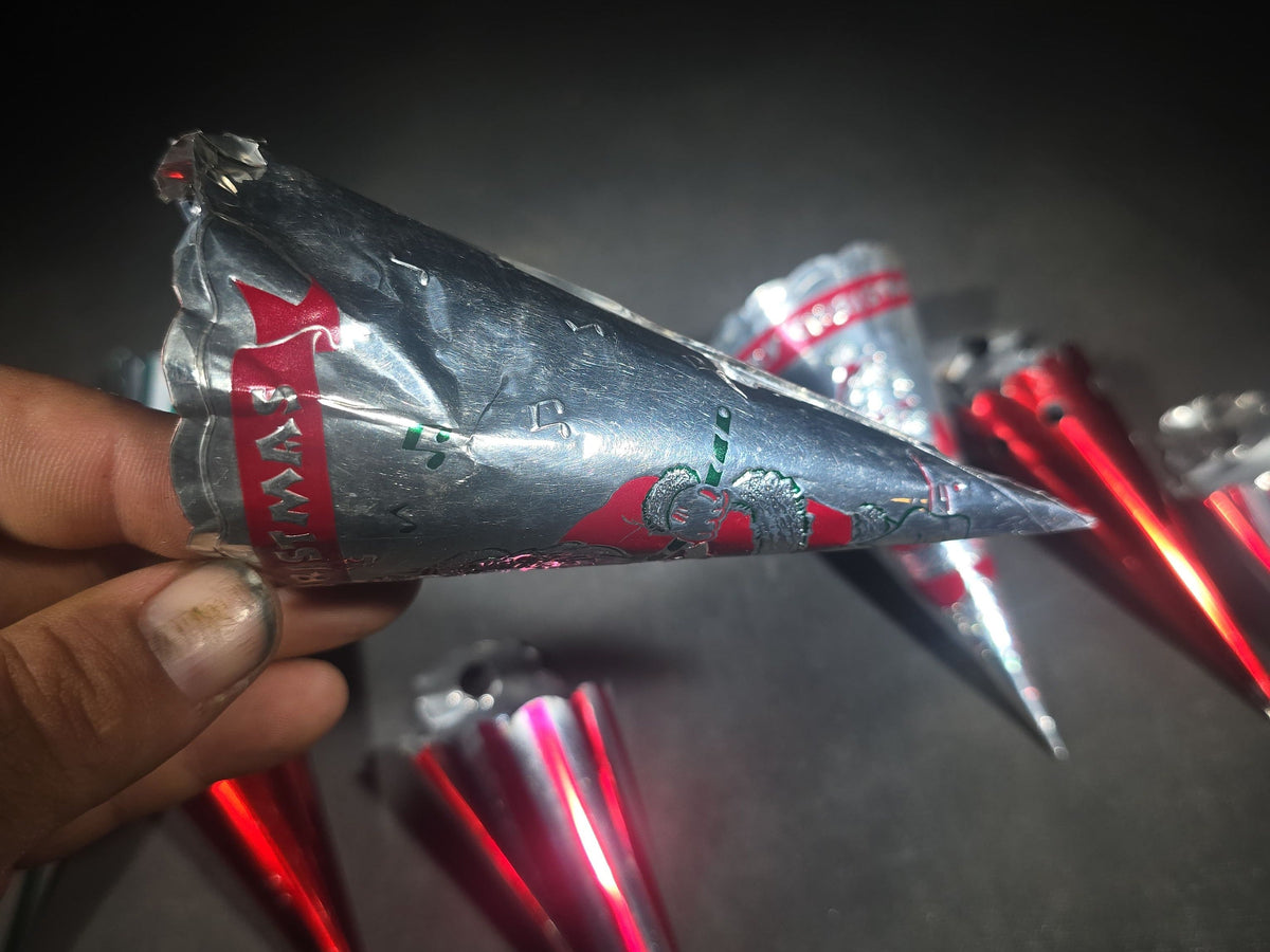 Grouping of Eight Vintage Metal Foil Christmas Candy Horn Ornaments including "Merry Christmas" Santa Claus Cones and Striped Varieties
