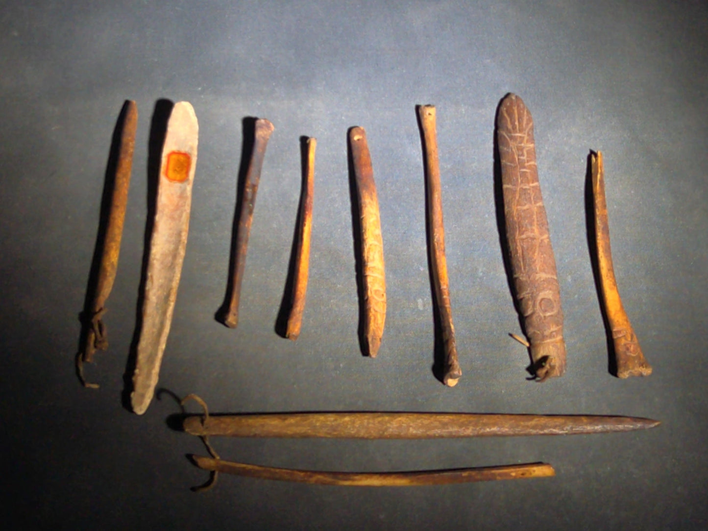 Grouping of 10 Antique Native American Carved Bone Implements including Incised and Relief-Carved Examples with Leather Ties and Drilled Holes