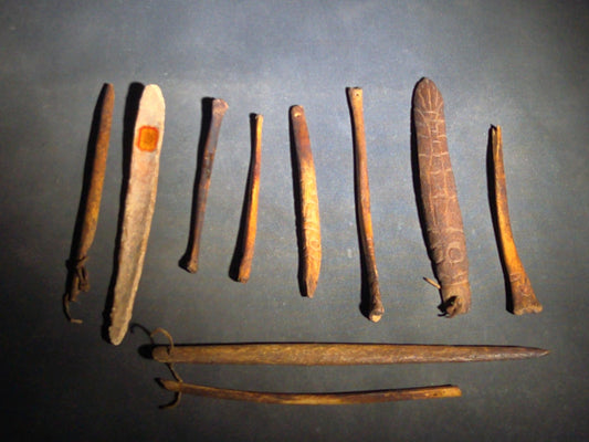 Grouping of 10 Antique Native American Carved Bone Implements including Incised and Relief-Carved Examples with Leather Ties and Drilled Holes