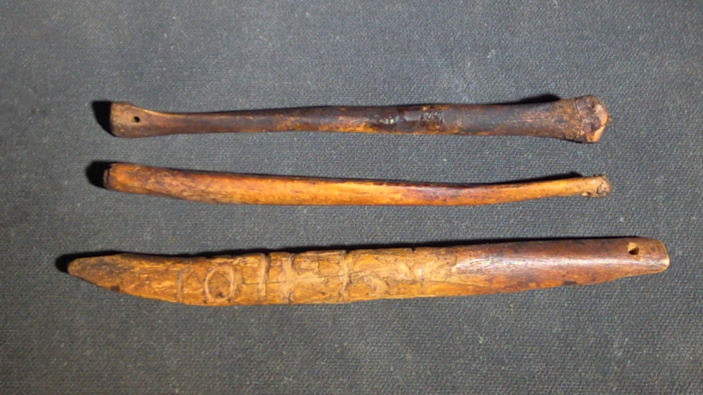 Grouping of 10 Antique Native American Carved Bone Implements including Incised and Relief-Carved Examples with Leather Ties and Drilled Holes