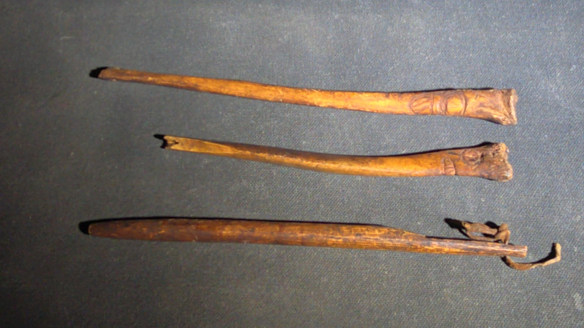 Grouping of 10 Antique Native American Carved Bone Implements including Incised and Relief-Carved Examples with Leather Ties and Drilled Holes