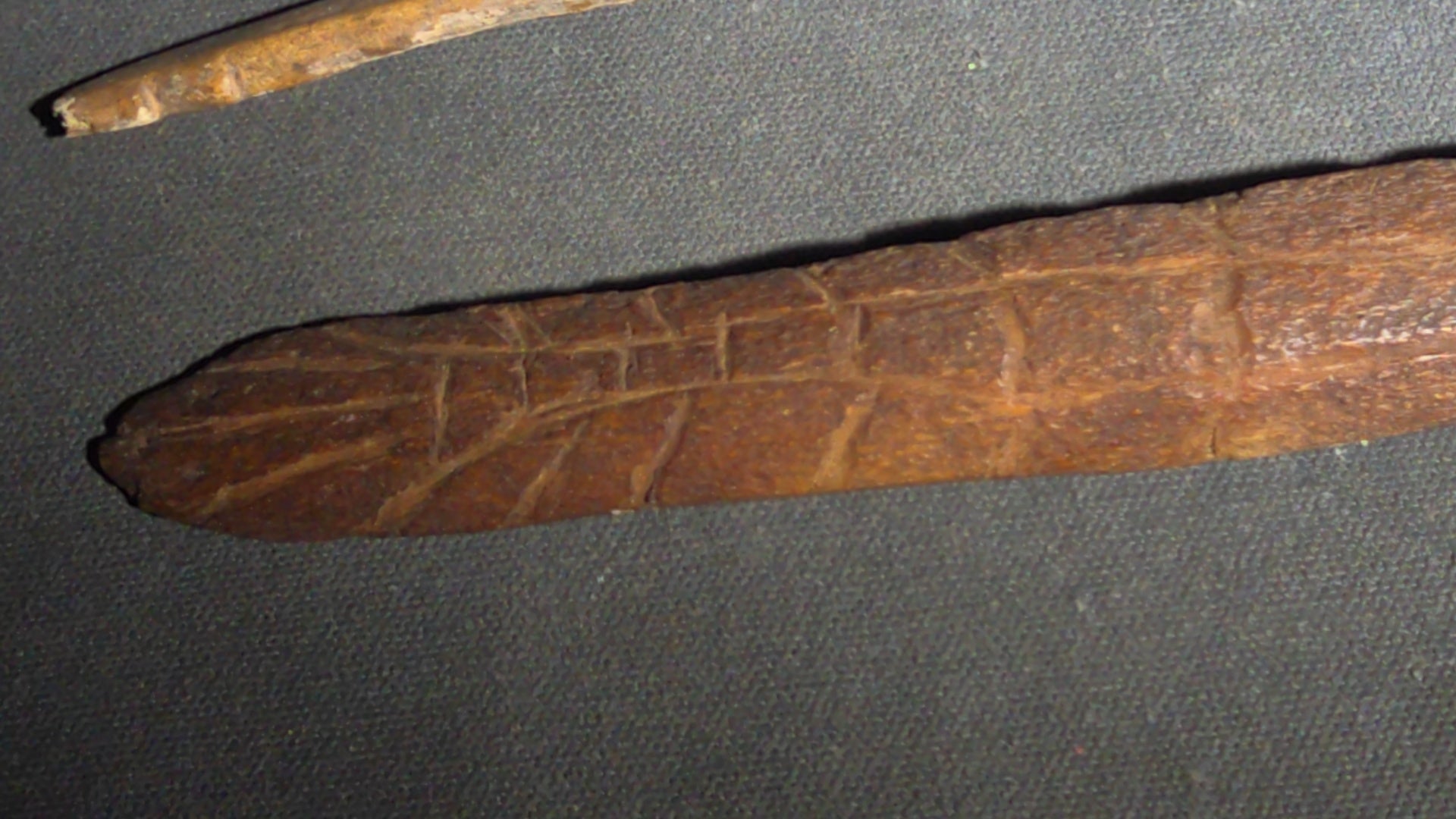 Grouping of 10 Antique Native American Carved Bone Implements including Incised and Relief-Carved Examples with Leather Ties and Drilled Holes