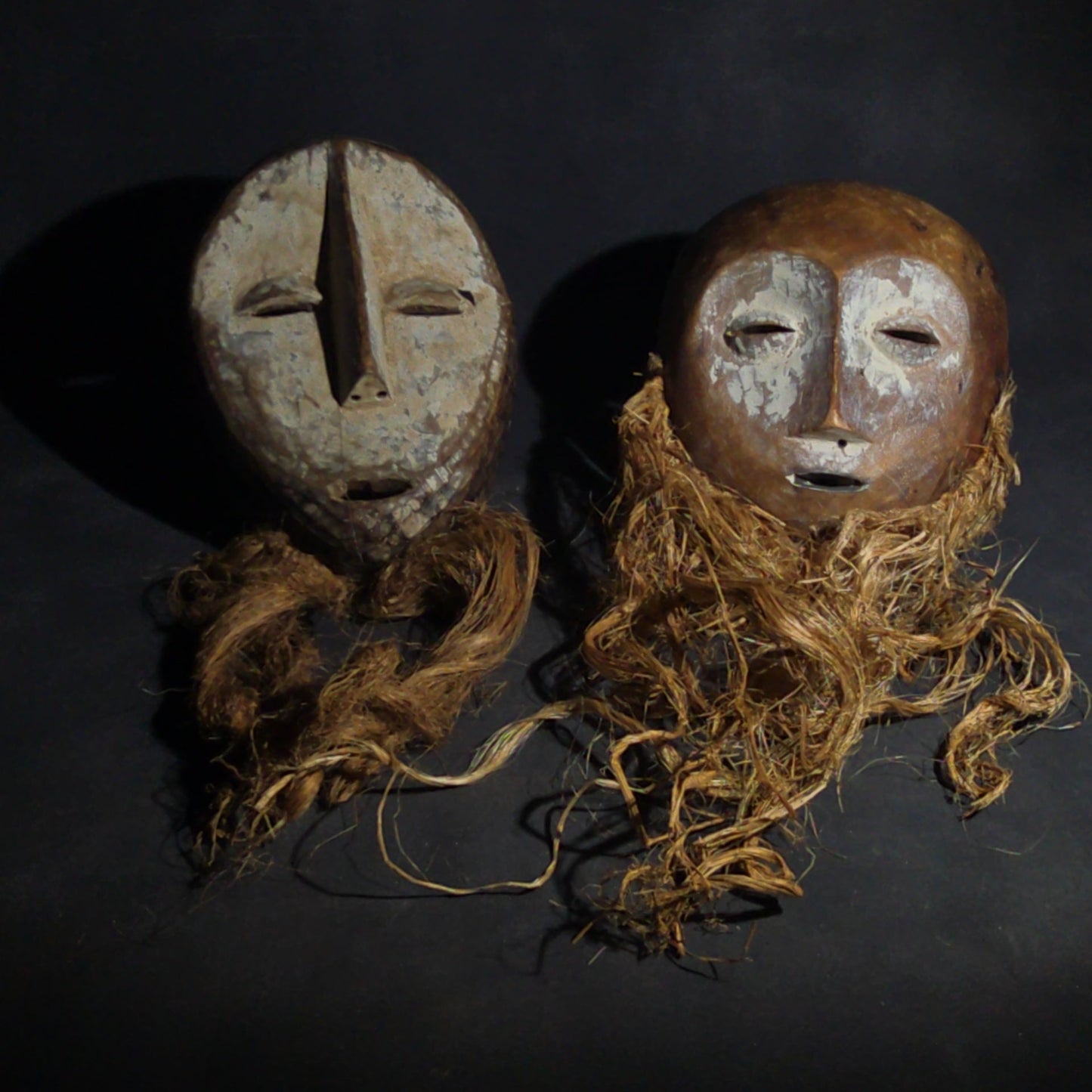 Pair of Vintage Lega Lukwakongo Carved Wood Masks with Raffia Beards, Democratic Republic of the Congo