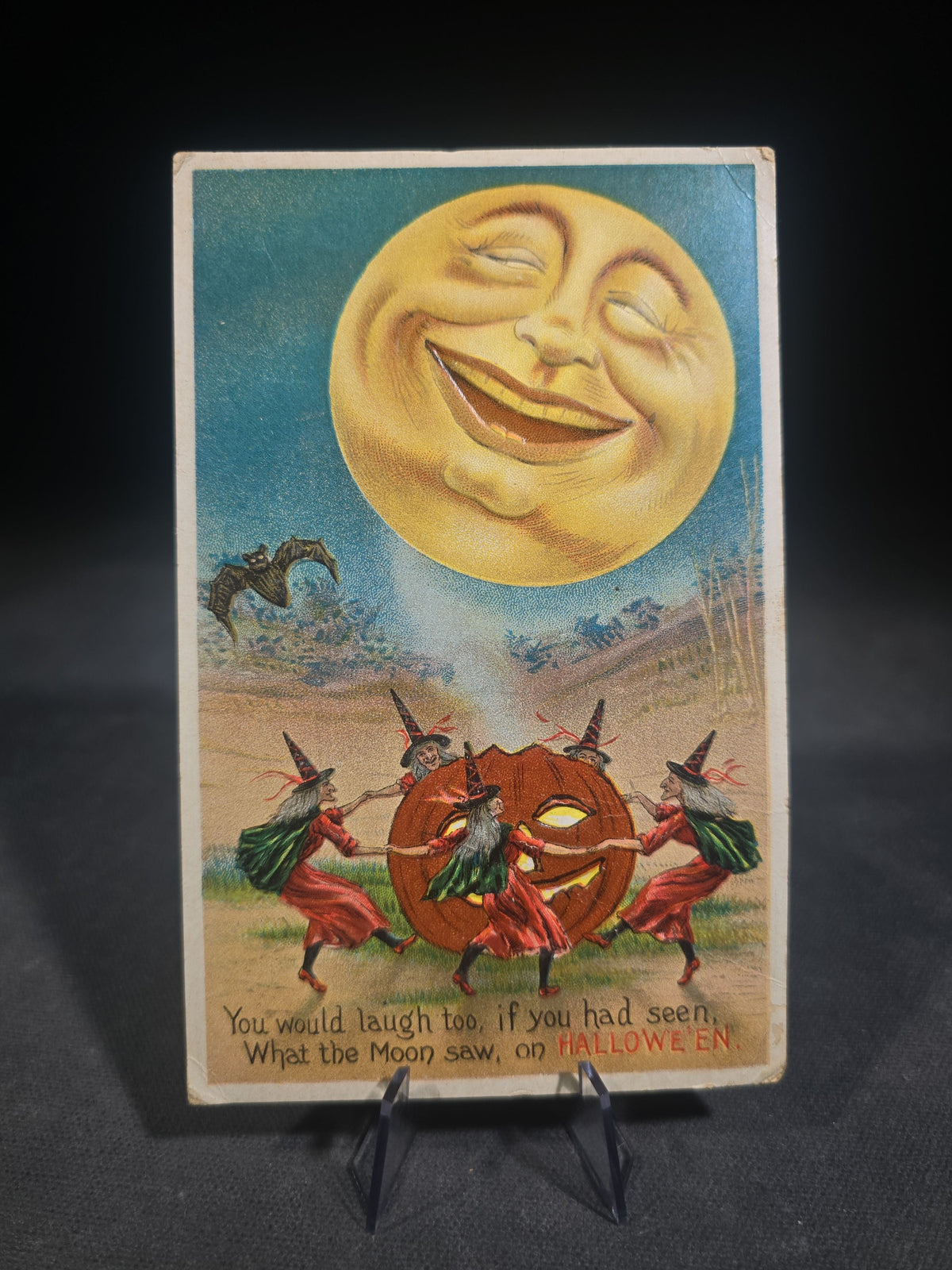 Antique Embossed Halloween Postcard with Laughing Man in the Moon, Witches Dancing Around a Jack-O-Lantern, and Bat, "You Would Laugh Too, If You Had Seen, What the Moon Saw, on Hallowe'en," No. 876/4, Unused