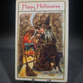 Lot 153 - Antique Halloween Postcard with Witch by Fireplace Cauldron, Black Cat, and Broom, "Happy Hallowe'en," Postmarked Massachusetts