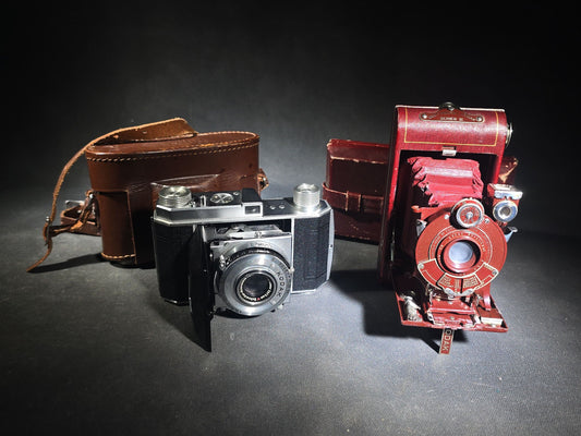 Pair of Antique and Vintage Kodak Folding Cameras including No. 1A Pocket Kodak Series II in Red with Kodak Anastigmat Lens and Kodak Retina 35mm Camera with Schneider-Kreuznach Xenar Lens, Compur-Rapid Shutter, and Leather Case