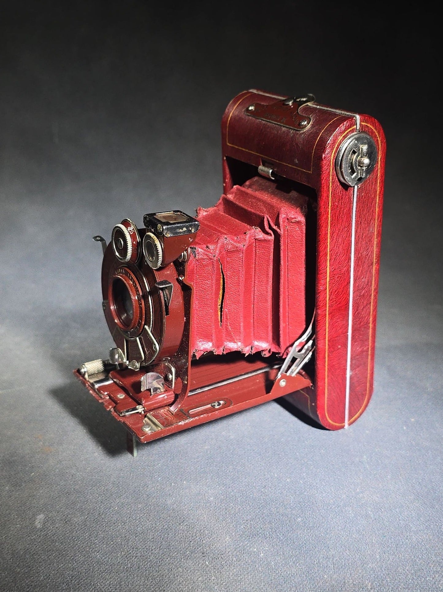 Pair of Antique and Vintage Kodak Folding Cameras including No. 1A Pocket Kodak Series II in Red with Kodak Anastigmat Lens and Kodak Retina 35mm Camera with Schneider-Kreuznach Xenar Lens, Compur-Rapid Shutter, and Leather Case