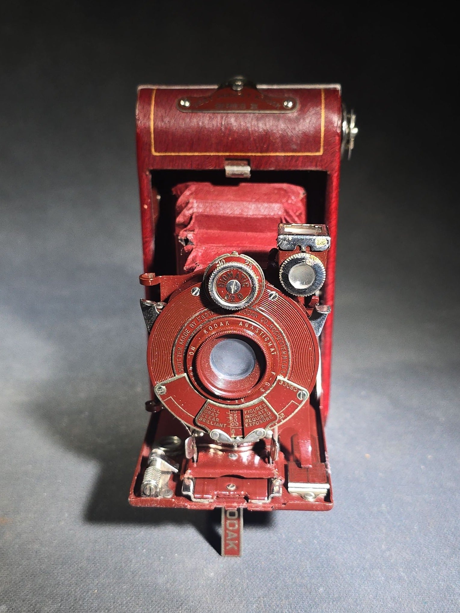 Pair of Antique and Vintage Kodak Folding Cameras including No. 1A Pocket Kodak Series II in Red with Kodak Anastigmat Lens and Kodak Retina 35mm Camera with Schneider-Kreuznach Xenar Lens, Compur-Rapid Shutter, and Leather Case
