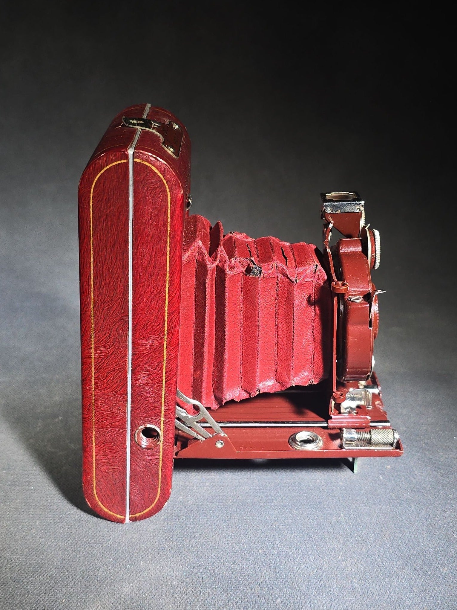 Pair of Antique and Vintage Kodak Folding Cameras including No. 1A Pocket Kodak Series II in Red with Kodak Anastigmat Lens and Kodak Retina 35mm Camera with Schneider-Kreuznach Xenar Lens, Compur-Rapid Shutter, and Leather Case