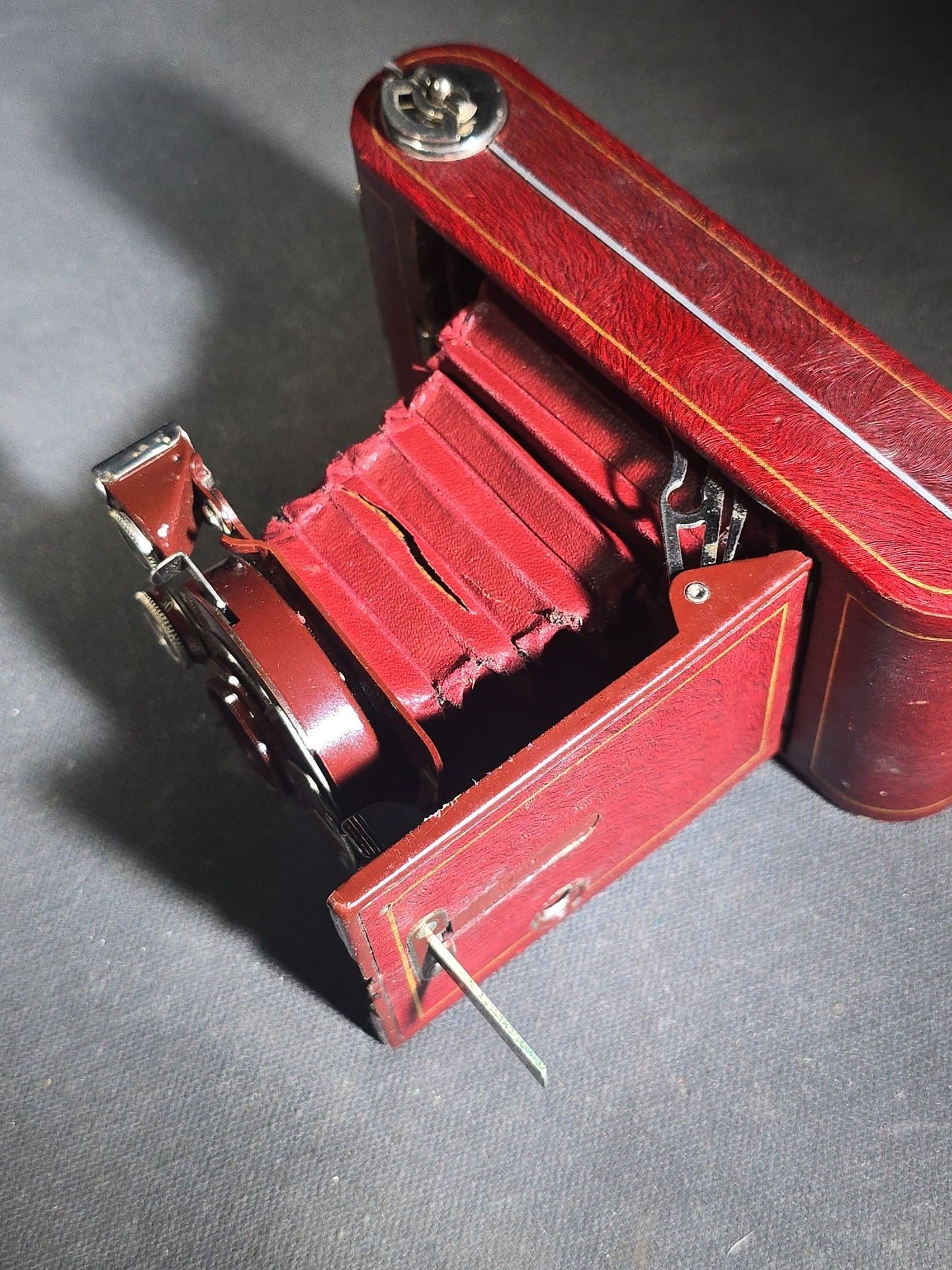 Pair of Antique and Vintage Kodak Folding Cameras including No. 1A Pocket Kodak Series II in Red with Kodak Anastigmat Lens and Kodak Retina 35mm Camera with Schneider-Kreuznach Xenar Lens, Compur-Rapid Shutter, and Leather Case