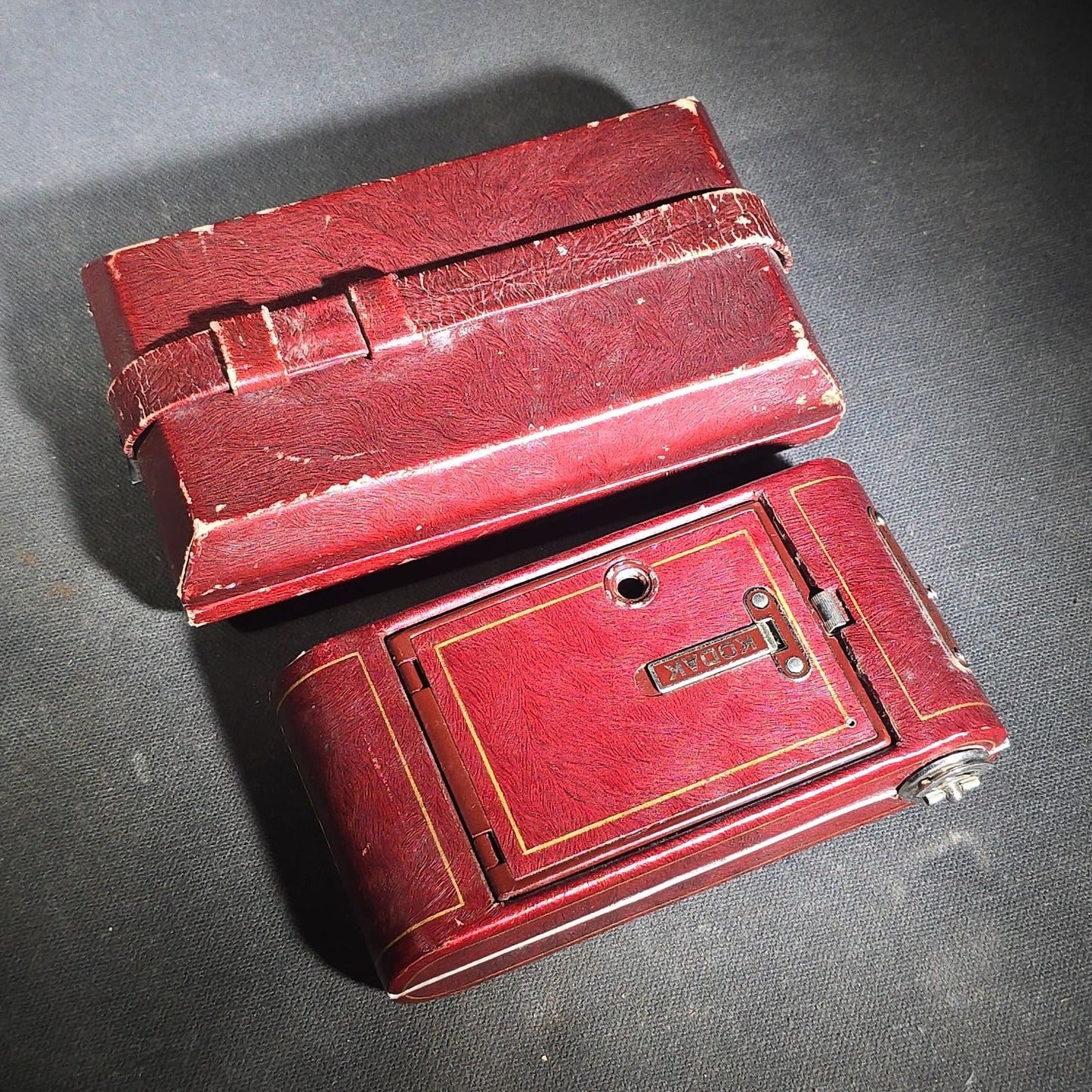 Pair of Antique and Vintage Kodak Folding Cameras including No. 1A Pocket Kodak Series II in Red with Kodak Anastigmat Lens and Kodak Retina 35mm Camera with Schneider-Kreuznach Xenar Lens, Compur-Rapid Shutter, and Leather Case