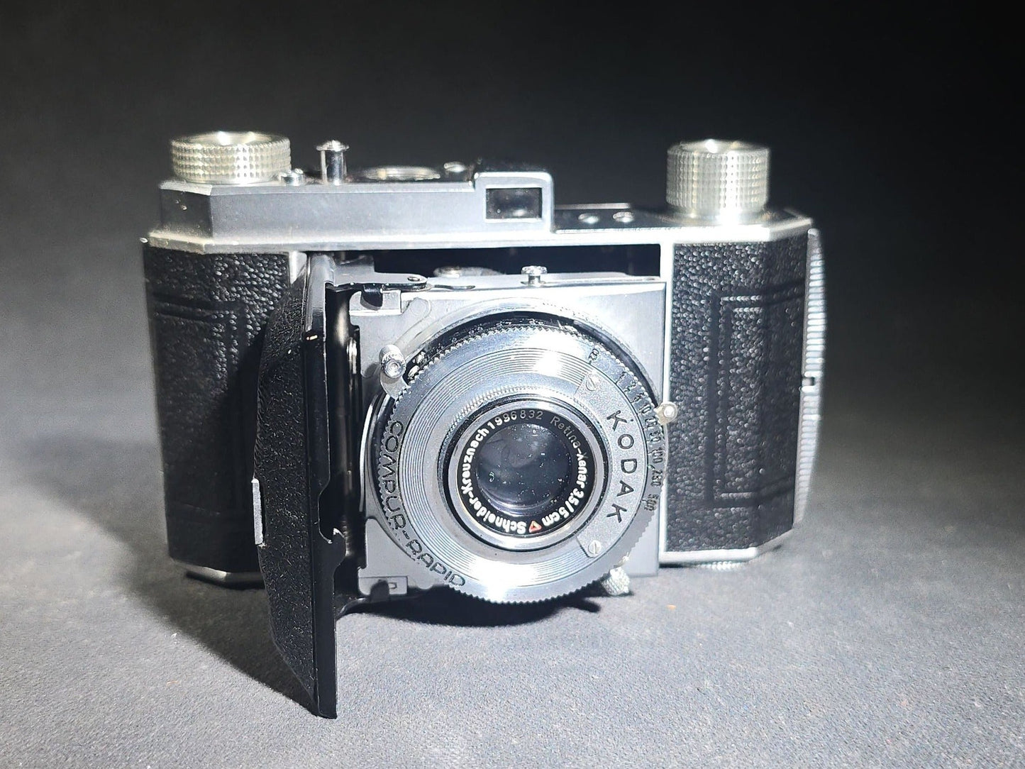 Pair of Antique and Vintage Kodak Folding Cameras including No. 1A Pocket Kodak Series II in Red with Kodak Anastigmat Lens and Kodak Retina 35mm Camera with Schneider-Kreuznach Xenar Lens, Compur-Rapid Shutter, and Leather Case