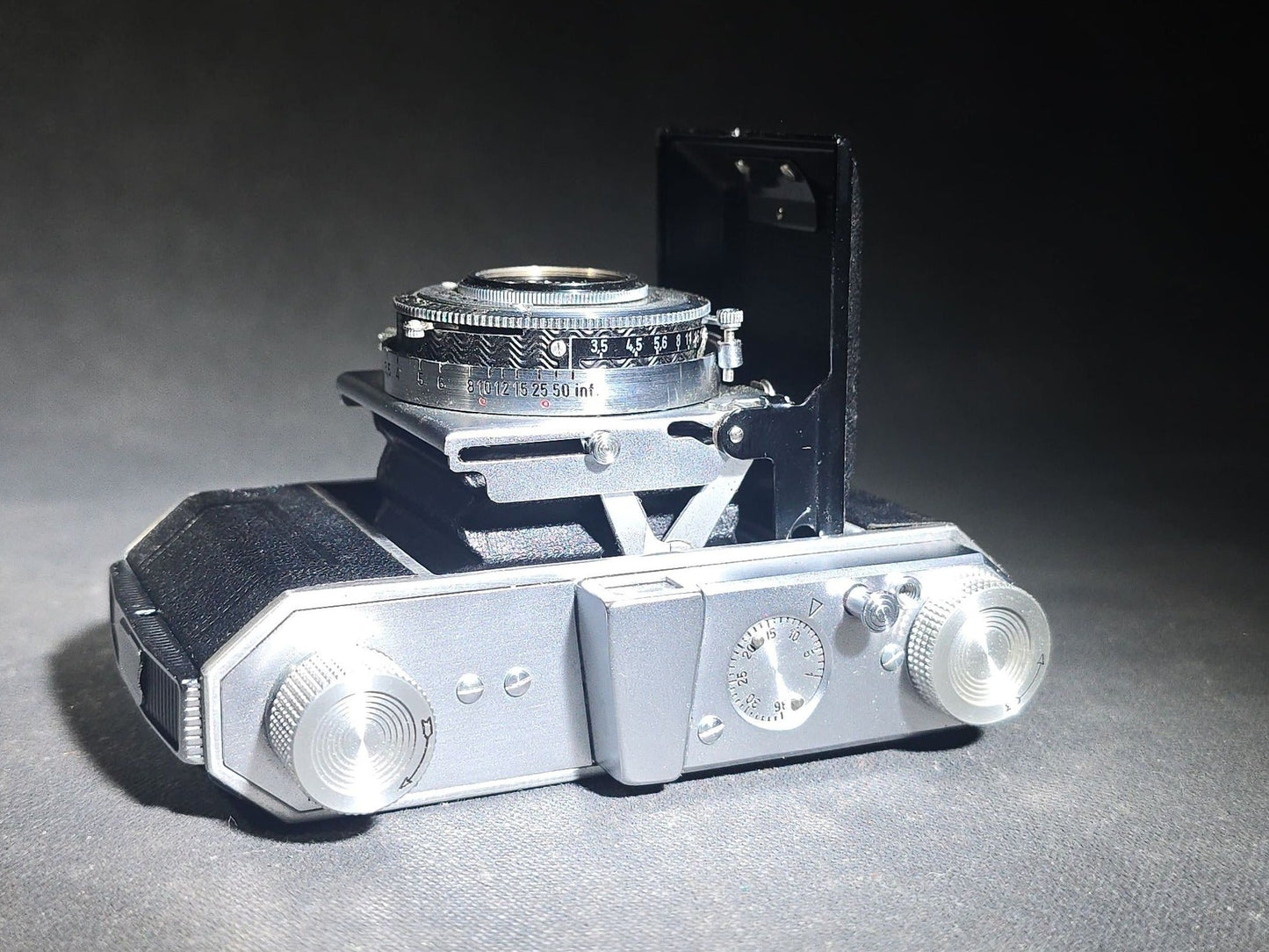 Pair of Antique and Vintage Kodak Folding Cameras including No. 1A Pocket Kodak Series II in Red with Kodak Anastigmat Lens and Kodak Retina 35mm Camera with Schneider-Kreuznach Xenar Lens, Compur-Rapid Shutter, and Leather Case