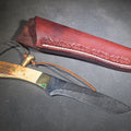 Lot 083 - Vintage Damascus Steel Fixed-Blade Knife with Bone Handle, Brass Bolster, and Tooled Leather Sheath, 11-3/4" L