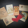 Lot 179 - Grouping of Seven Antique and Vintage Christmas Ephemera Including Santa Claus with Children in Sleigh R.P.P.C., Quincy Savings Bank Die-Cut Stocking Dime Holder, Personal Finance Company Advertising Needle Case, and Anti-New Deal Humorous Poem