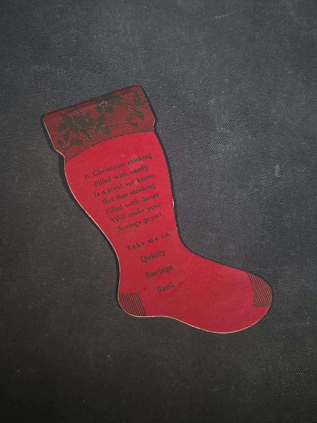 Grouping of Seven Antique and Vintage Christmas Ephemera including Santa Claus with Children in Sleigh R.P.P.C., Quincy Savings Bank Die-Cut Stocking Dime Holder, Personal Finance Company Advertising Needle Case, and Anti-New Deal Humorous Poem