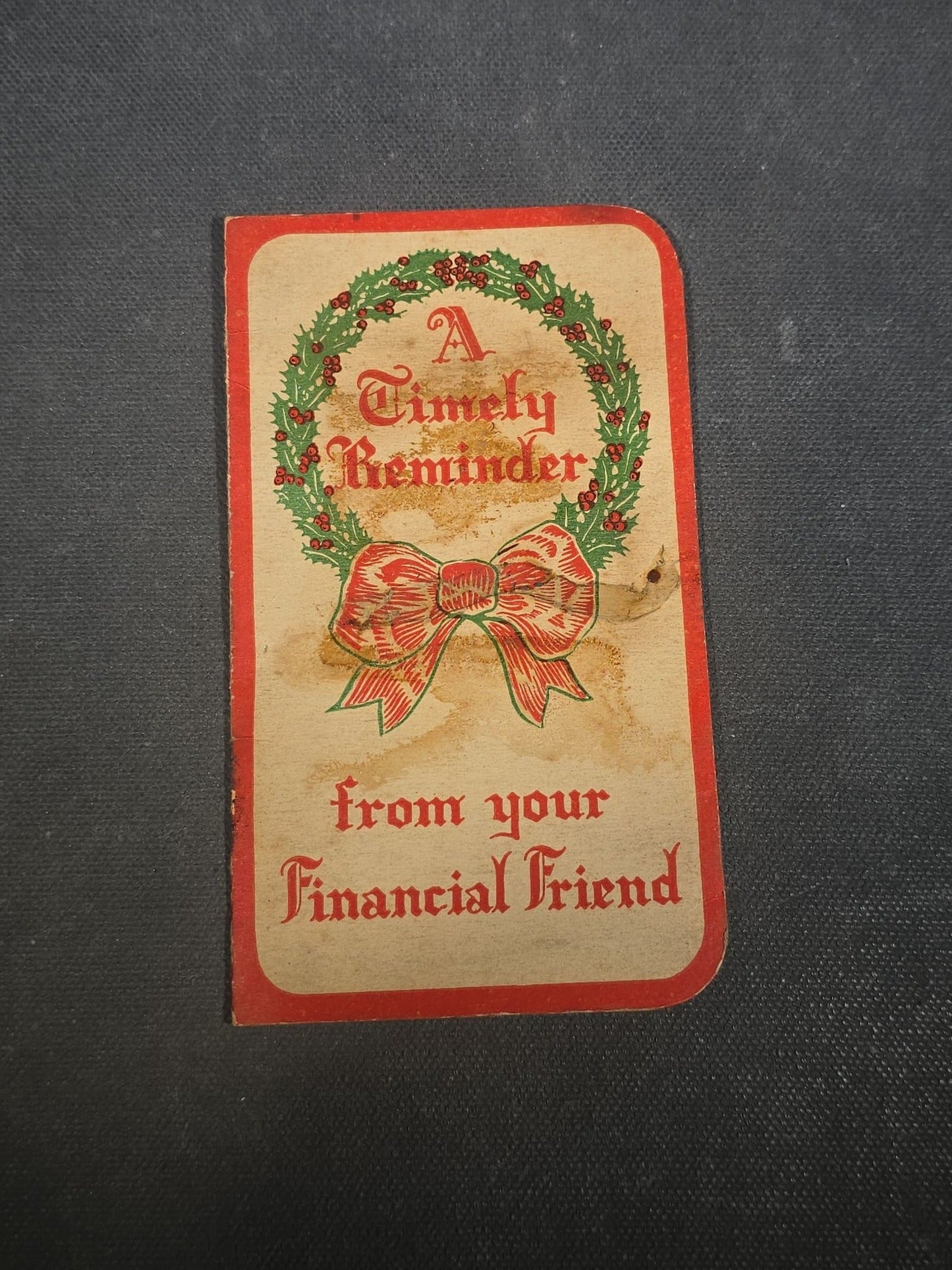 Grouping of Seven Antique and Vintage Christmas Ephemera including Santa Claus with Children in Sleigh R.P.P.C., Quincy Savings Bank Die-Cut Stocking Dime Holder, Personal Finance Company Advertising Needle Case, and Anti-New Deal Humorous Poem