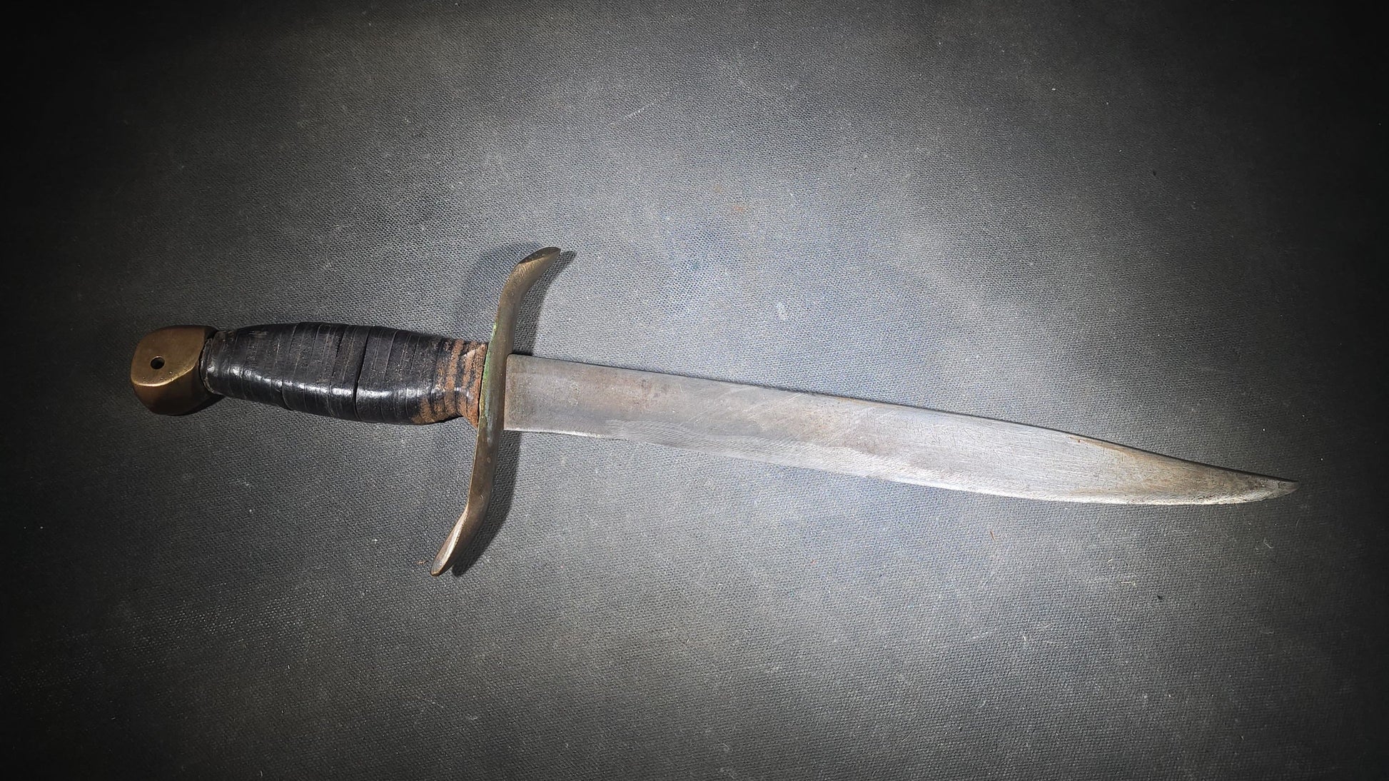 Vintage Bowie-Style Fighting Knife with Stacked Leather Grip, Brass Crossguard and Pommel, and Leather Sheath