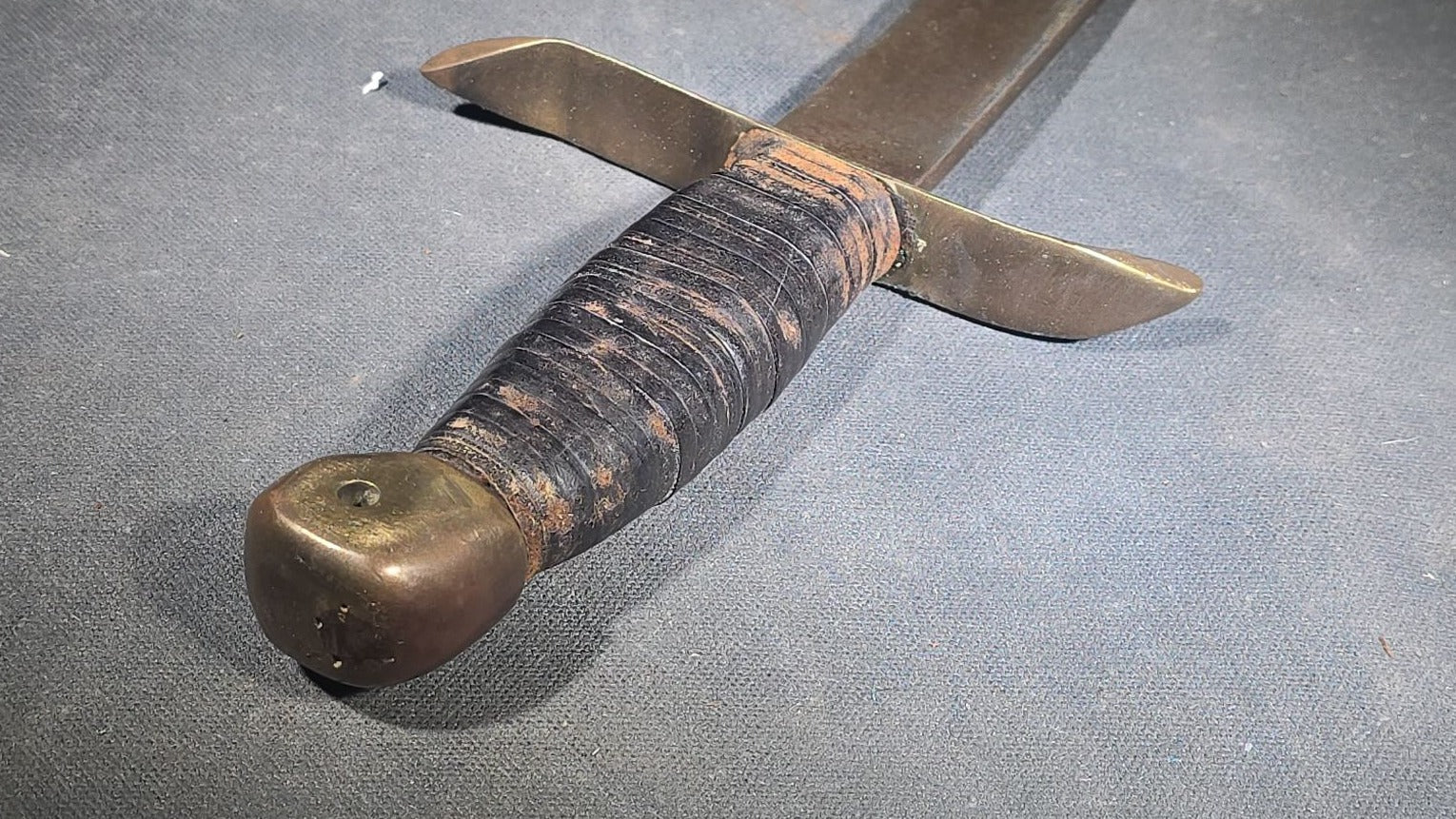 Vintage Bowie-Style Fighting Knife with Stacked Leather Grip, Brass Crossguard and Pommel, and Leather Sheath