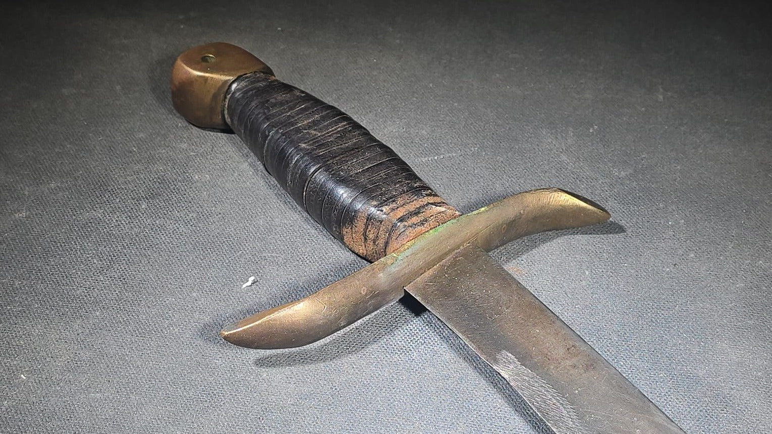 Vintage Bowie-Style Fighting Knife with Stacked Leather Grip, Brass Crossguard and Pommel, and Leather Sheath