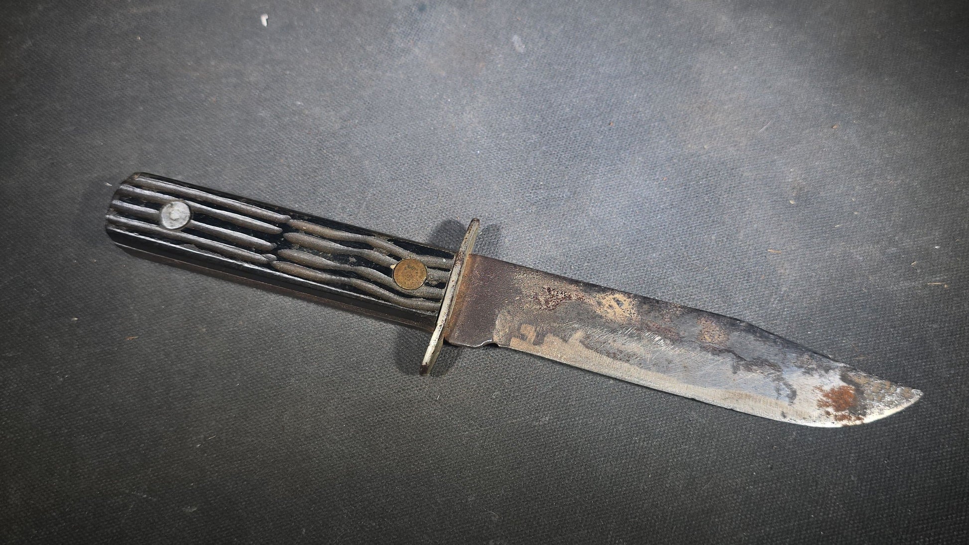 Vintage Fixed-Blade Knife with Grooved Handle and Leather Sheath