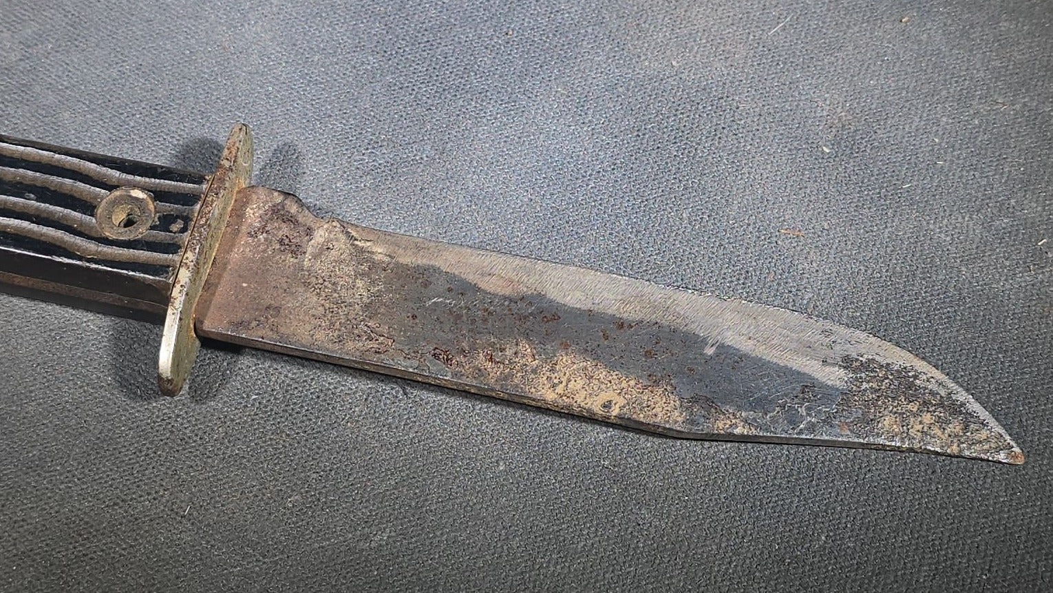 Vintage Fixed-Blade Knife with Grooved Handle and Leather Sheath
