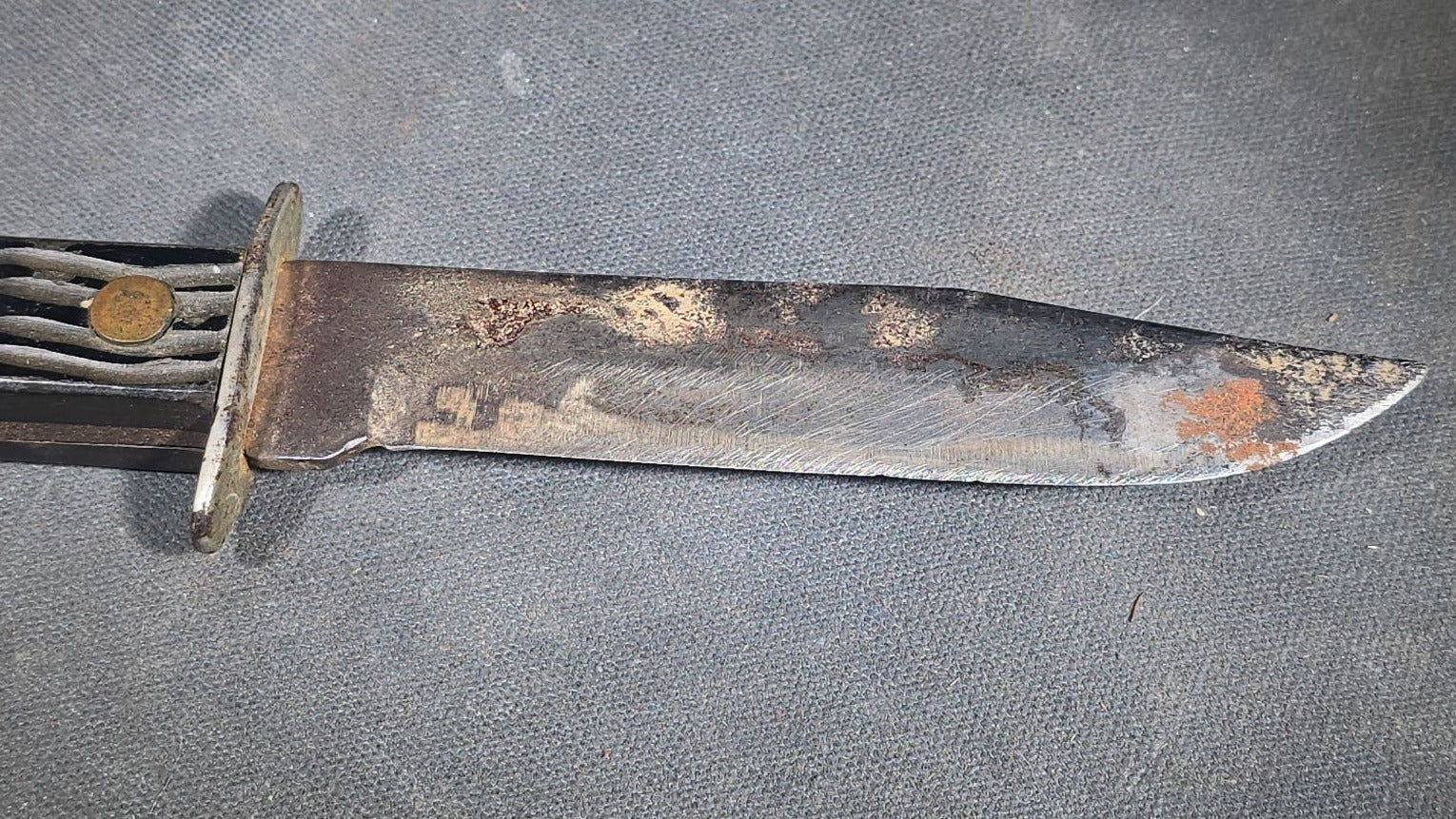 Vintage Fixed-Blade Knife with Grooved Handle and Leather Sheath