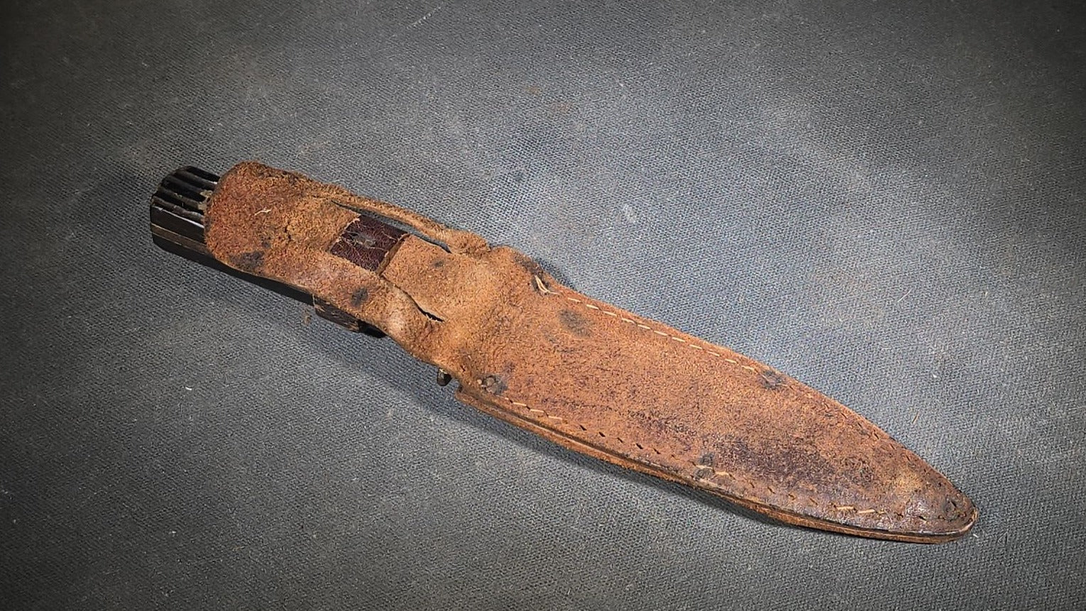 Vintage Fixed-Blade Knife with Grooved Handle and Leather Sheath