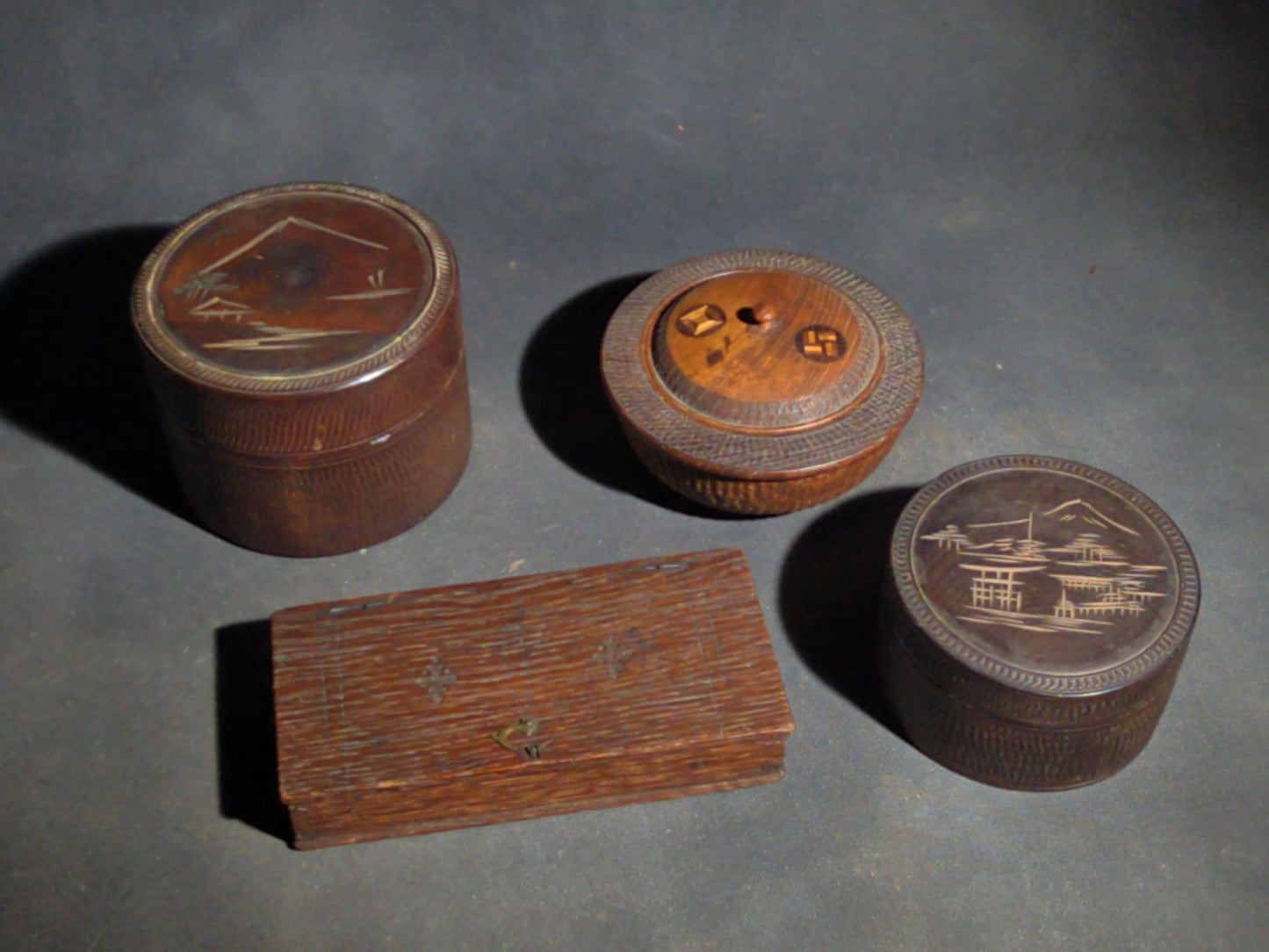 Grouping of Four Vintage Wood Boxes including Two Japanese Lidded Round Boxes with Mount Fuji Landscapes and Japanese Coaster Set, and Antique English Coin Balance Box with Currency Table
