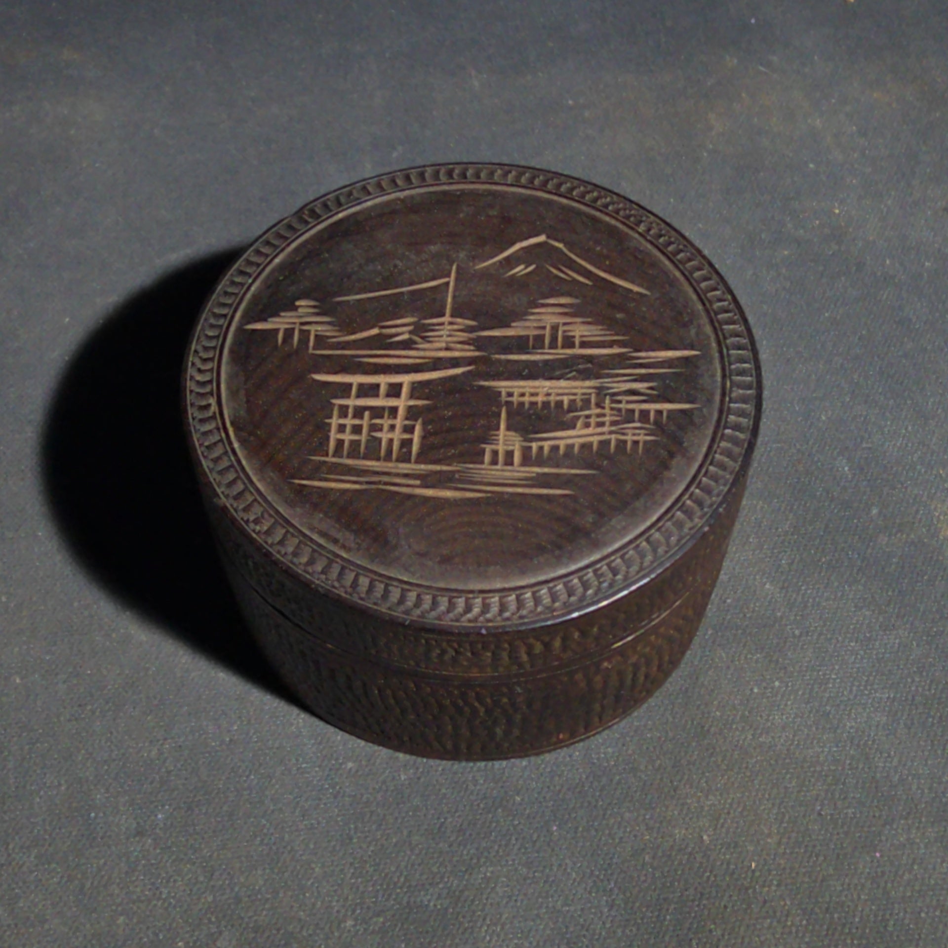 Grouping of Four Vintage Wood Boxes including Two Japanese Lidded Round Boxes with Mount Fuji Landscapes and Japanese Coaster Set, and Antique English Coin Balance Box with Currency Table