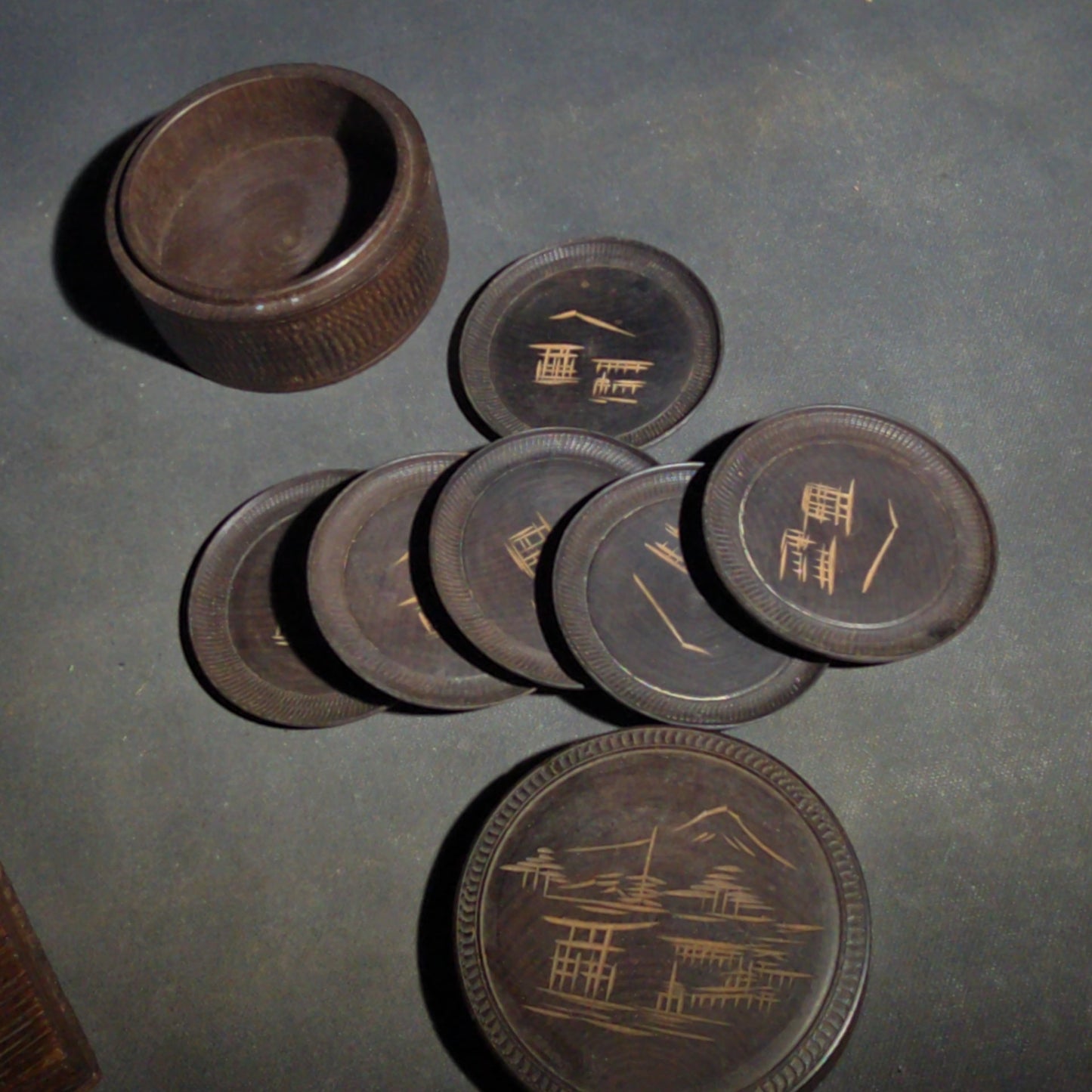 Grouping of Four Vintage Wood Boxes including Two Japanese Lidded Round Boxes with Mount Fuji Landscapes and Japanese Coaster Set, and Antique English Coin Balance Box with Currency Table