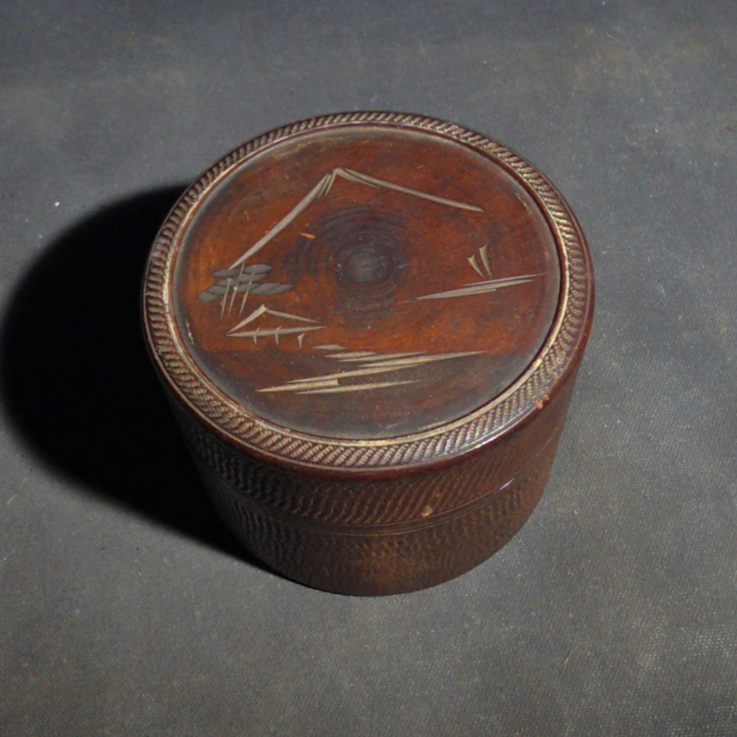 Grouping of Four Vintage Wood Boxes including Two Japanese Lidded Round Boxes with Mount Fuji Landscapes and Japanese Coaster Set, and Antique English Coin Balance Box with Currency Table