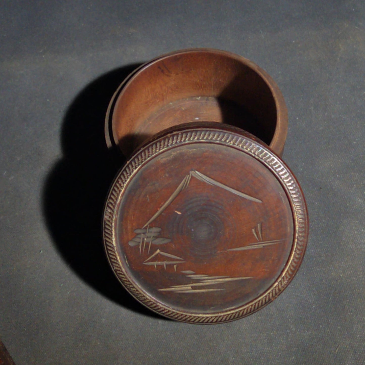 Grouping of Four Vintage Wood Boxes including Two Japanese Lidded Round Boxes with Mount Fuji Landscapes and Japanese Coaster Set, and Antique English Coin Balance Box with Currency Table