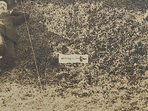 Antique Board-Mounted "Selfie" Photograph of a Group of Men Arranged in the Shape of the Letter "H" with "Hikers" Banner and Cross, Self-Timed Shutter Release