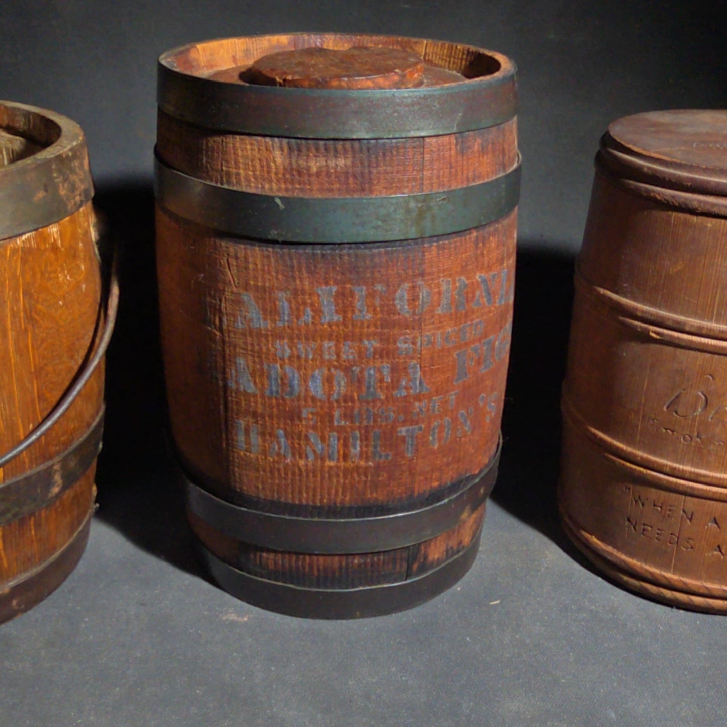 Trio of Antique Wooden Advertising Containers including F.W. Devoe & Co. White Lead Bucket with Brass Plaque, Hamilton's California Kadota Figs Barrel, and Briggs Smoking Tobacco Barrel