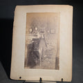 Lot 086 - Antique Board-Mounted "Selfie" Photograph of a Large Format Camera on Tripod in a Domestic Interior, Mirror Self-Portrait, Ex-Album Page with Photograph of a Vacant Lot with Buildings on Verso