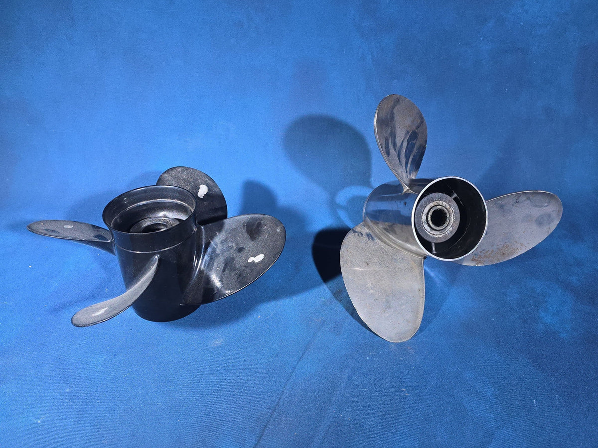 Pair of Vintage Three-Blade Boat Propellers including a Michigan Wheel Vortex Four-Blade and a Stainless Steel Three-Blade