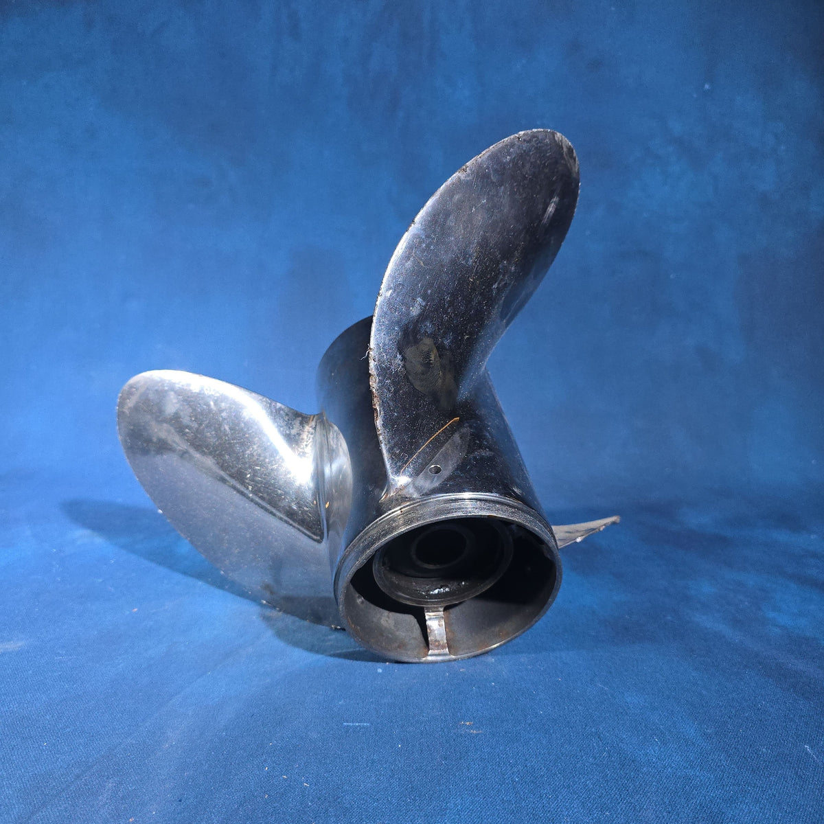 Pair of Vintage Three-Blade Boat Propellers including a Michigan Wheel Vortex Four-Blade and a Stainless Steel Three-Blade