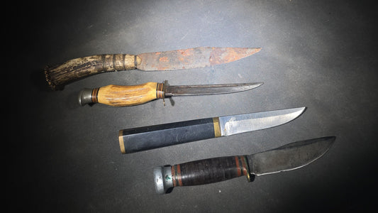 Grouping of Four Vintage Fixed-Blade Knives including Marble's Stacked Leather Handle Knife, Stag Handle Knife, and Bone Handle Dagger