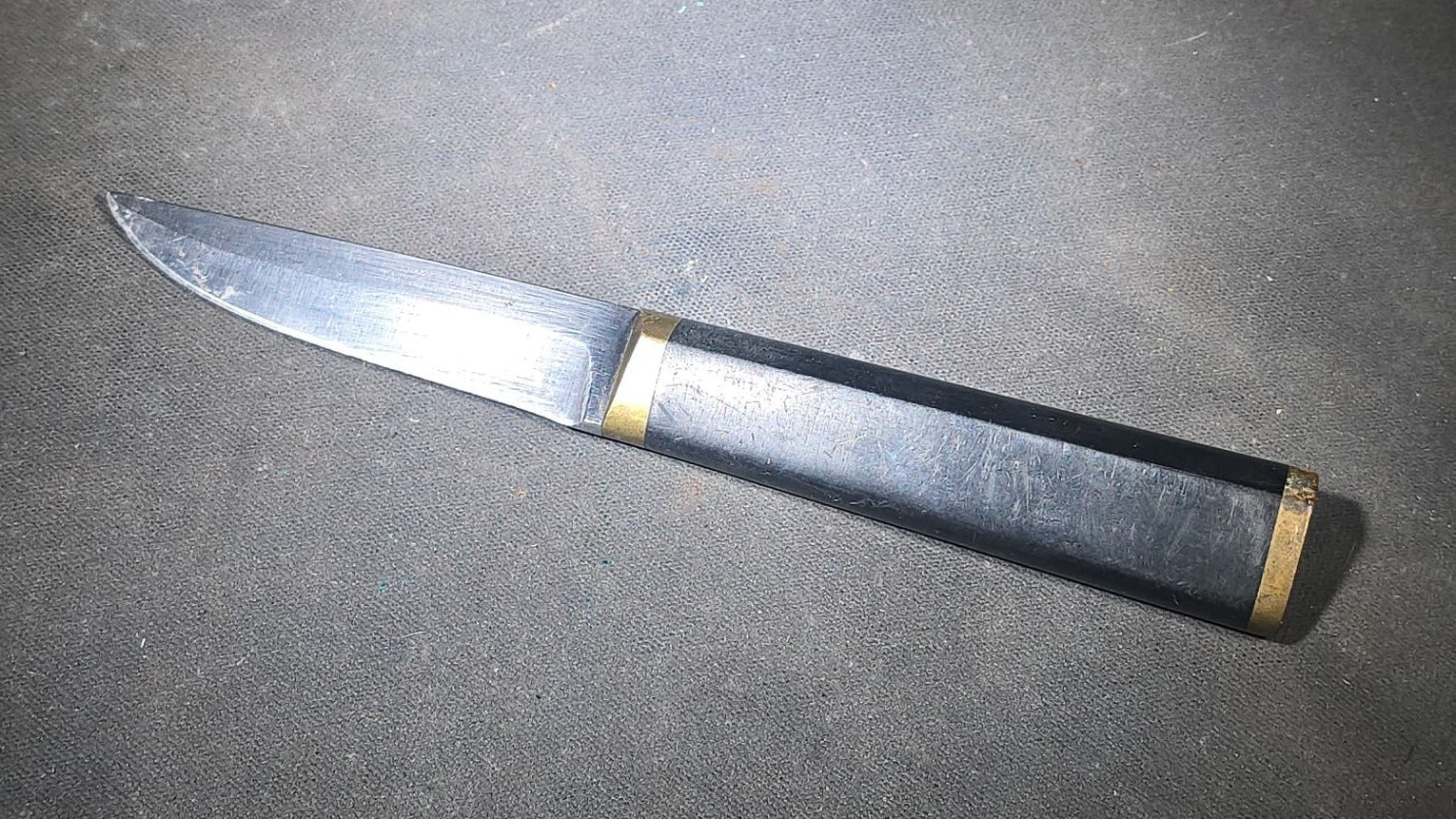 Grouping of Four Vintage Fixed-Blade Knives including Marble's Stacked Leather Handle Knife, Stag Handle Knife, and Bone Handle Dagger