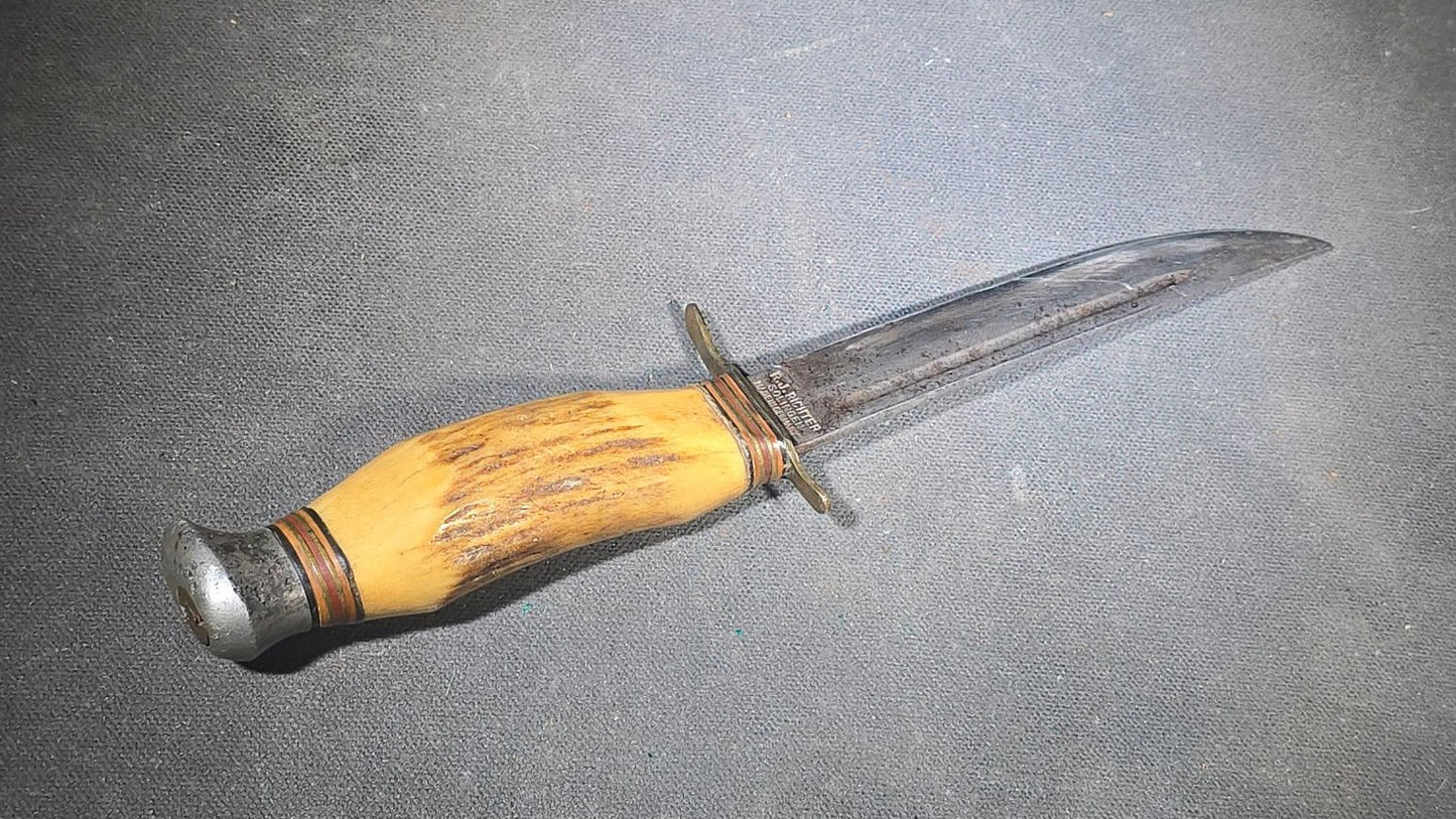 Grouping of Four Vintage Fixed-Blade Knives including Marble's Stacked Leather Handle Knife, Stag Handle Knife, and Bone Handle Dagger