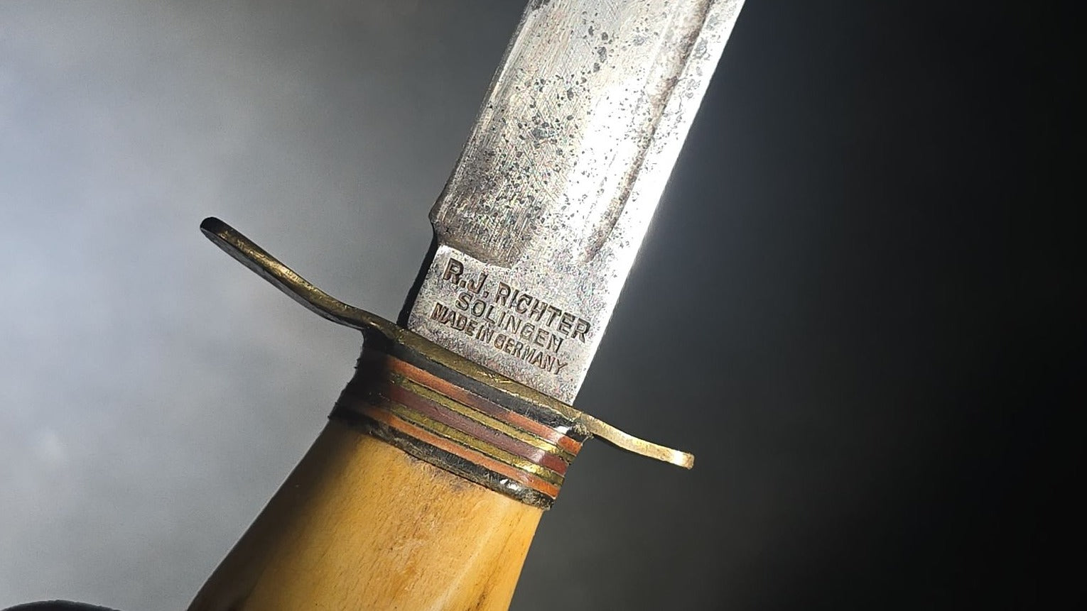 Grouping of Four Vintage Fixed-Blade Knives including Marble's Stacked Leather Handle Knife, Stag Handle Knife, and Bone Handle Dagger