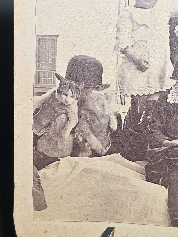 Grouping of Four Antique and Vintage Photographs including C.D.V. Family Portrait with Cat, WWI Soldier R.P.P.C., Board-Mounted Musicians with Violin and Banjo, and Snapshot of Child Cowboy