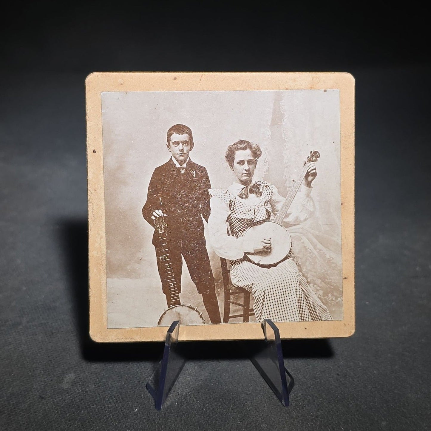 Grouping of Four Antique and Vintage Photographs including C.D.V. Family Portrait with Cat, WWI Soldier R.P.P.C., Board-Mounted Musicians with Violin and Banjo, and Snapshot of Child Cowboy