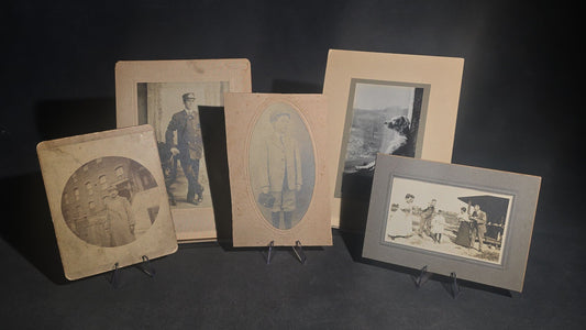 Grouping of Five Antique and Vintage Board-Mounted Photographs including Boy Holding a Box Camera, Two Men in Uniform, Family Eating Watermelon, and Dog Looking Out a Window, One Photographed by Rogers, New Haven, Connecticut