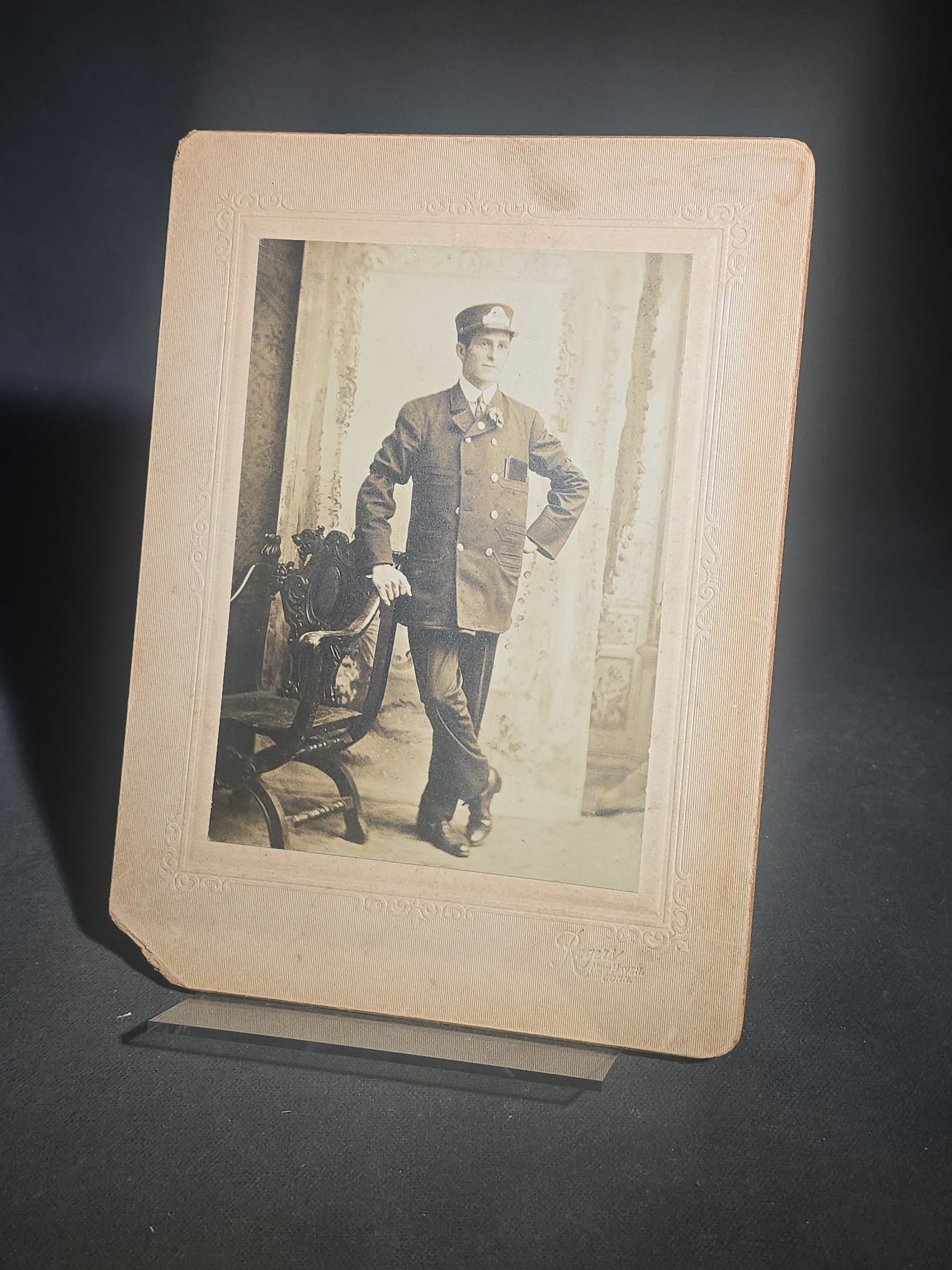 Grouping of Five Antique and Vintage Board-Mounted Photographs including Boy Holding a Box Camera, Two Men in Uniform, Family Eating Watermelon, and Dog Looking Out a Window, One Photographed by Rogers, New Haven, Connecticut